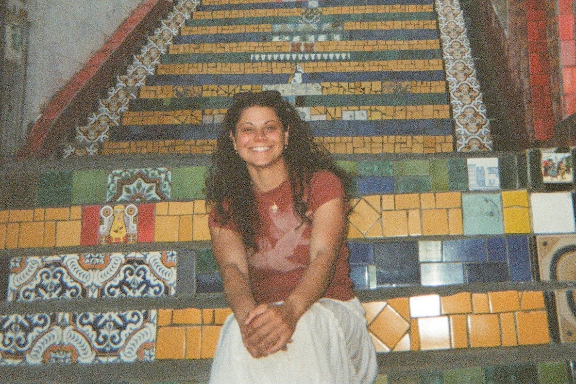 Katie sitting on a flight of tiled mosaic steps, shot on film